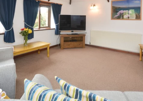 Wagtail Cottage, Tregolds is a traditional stone retreat near St Merryn, surrounded by peaceful countryside views, featuring sunny enclosed gardens, contemporary coastal interiors, and easy access to the Seven Bays beaches and South West Coast Path.
