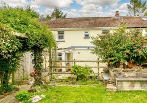 The patio, alfresco dining area leads to the lawned garden at Water Terrace, Combe Martin