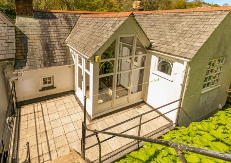 From the patio, steps lead up to a higher patio & alfresco dining area