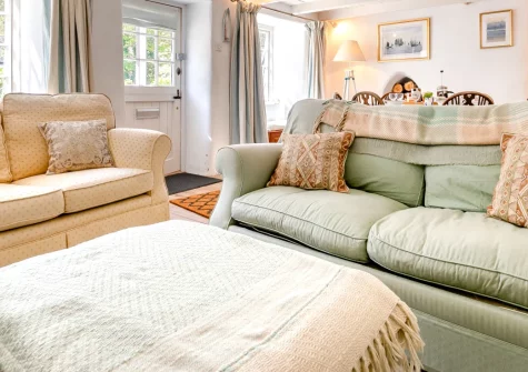 Wednesday Cottage, Helford is a characterful three-bedroom retreat at the peaceful head of the Helford river, featuring inglenook fireplace, elevated terrace with village views, and easy access to Cornwall's southern coast and waterside adventures.