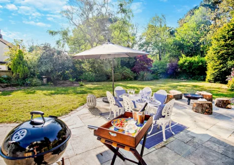 The patio, barbecue, alfresco dining area & large south facing garden at West Cottage, Trescowe