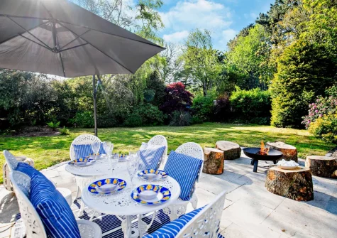 The patio, alfresco dining area, firepit & large south facing garden at West Cottage, Trescowe