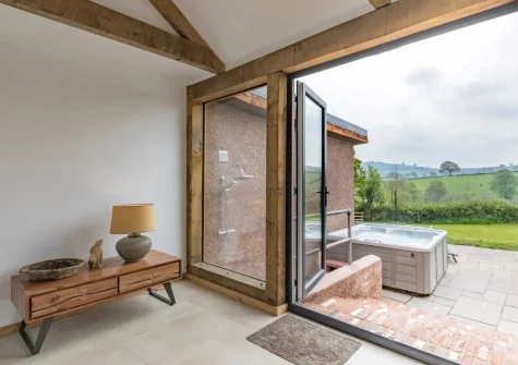 The sun room leads out to the terrace, outdoor shower & hot tub at West Farleigh Farmhouse, Cadeleigh