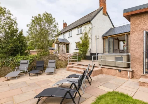 The terrace, hot tub & outdoor sitting area at West Farleigh Farmhouse, Cadeleigh