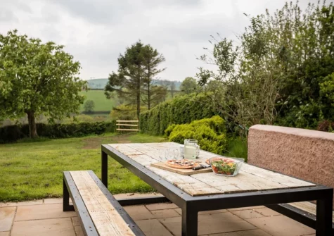 The terrace, alfresco dining area & garden at West Farleigh Farmhouse, Cadeleigh