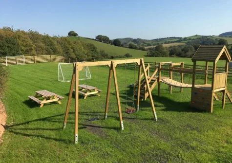The shared outdoor children's play area at West Farleigh Farmhouse, Cadeleigh
