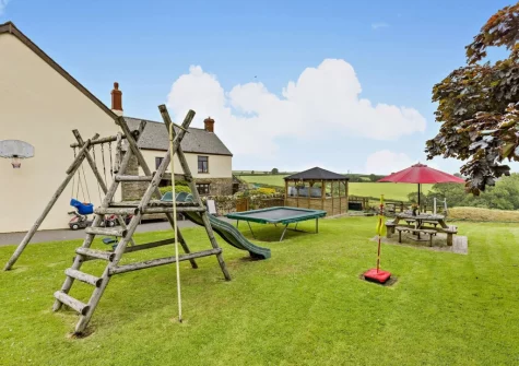 The garden with children's play facilities at West Goldsworthy Farm, Horns Cross