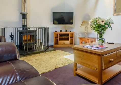 West Pennicknold Barn, Shebbear is a stylishly renovated threshing barn offering spectacular Devon country views, three bedrooms, a games barn, & private garden. Perfect for families seeking a rural retreat with easy access to beaches & attractions.