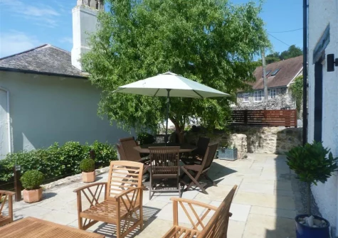 The sun-trap patio, barbecue & alfresco dining area at West View Cottage, Beer
