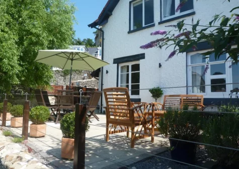 The sun-trap patio, barbecue & alfresco dining area at West View Cottage, Beer