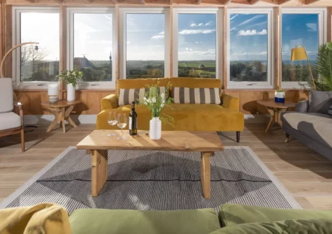 Westaway House, Trelights is a magnificent six-bedroom coastal retreat with panoramic sea views across to Bodmin Moor, featuring a solar-heated outdoor pool, wood-fired hot tub, exceptional pool house with mezzanine, and Port Isaac close by.