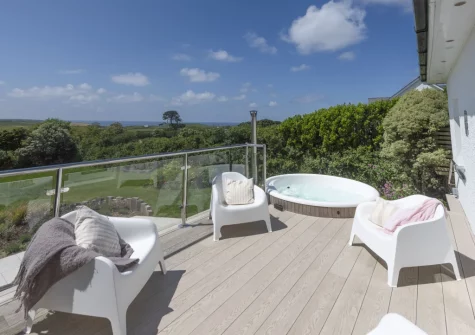 The patio, wood-fired hot tub & outdoor sitting area at Westaway House, Trelights