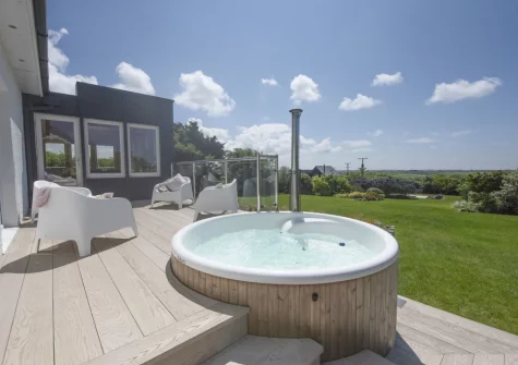 The patio, wood-fired hot tub & outdoor sitting area at Westaway House, Trelights