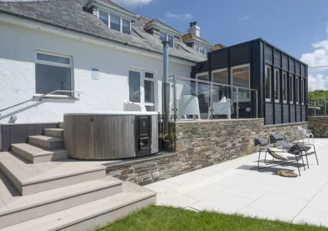 The patio, wood-fired hot tub & outdoor sitting area at Westaway House, Trelights