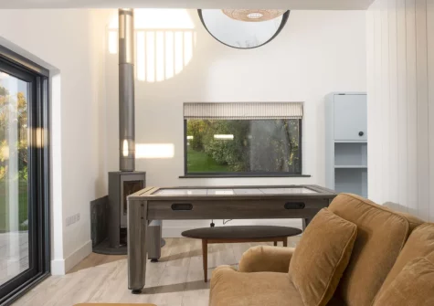 The poolhouse, with woodbuning stove, games table & sitting area at Westaway House, Trelights