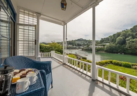 A large veranda runs the length of the house with generous amounts of seating & a full view of Newton Creek.