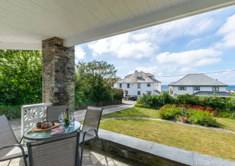 The covered Cornish slate terrace, outdoor sitting area & garden at Westhaven, Trevone