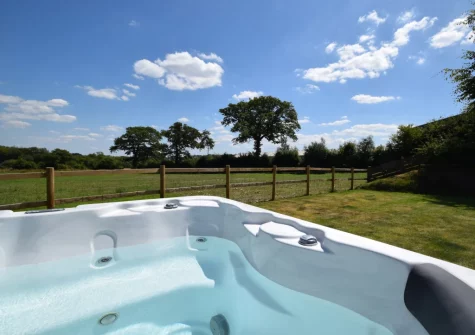 The hot tub & enclosed garden at Weston Farm Barn, East Knowstone