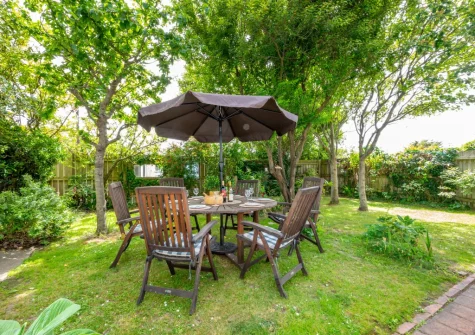 The south-facing enclosed garden with barbecue & alfresco dining area at Westover House, Croyde