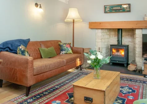 Wheelwright Cottage, Branscombe is a beautiful three-bedroom retreat in the heart of an unspoilt Devon village, featuring vaulted ceilings, a wood burner, stylish granite kitchen, and pretty patio garden, just a ten-minute level walk from the beach.