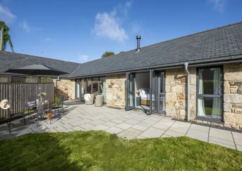 The patio, alfresco dining, outdoor sitting area & enlosed garden at Whitewood, Carnhell Green