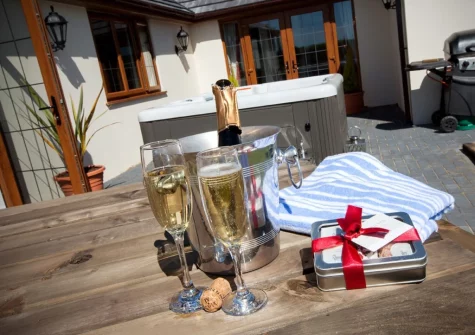 The courtyard, barbecue, alfresco dining area & hot tub at Wildflower Cottage, Westward Ho!