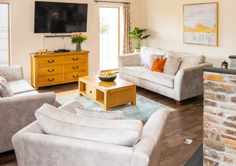 Wildflower Cottage, Westward Ho! is a stunning single-storey retreat on a clifftop estate above golden sands, featuring a private hot tub with ocean views, contemporary interiors, direct coast path access, and shared leisure facilities.