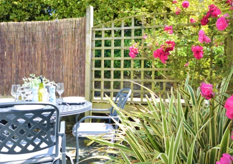 The enclosed tiered patio garden & outdoor sitting area at Willow Cottage, St Merryn