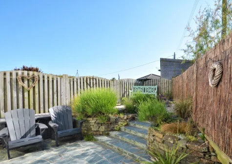 The enclosed tiered patio garden & outdoor sitting area at Willow Cottage, St Merryn