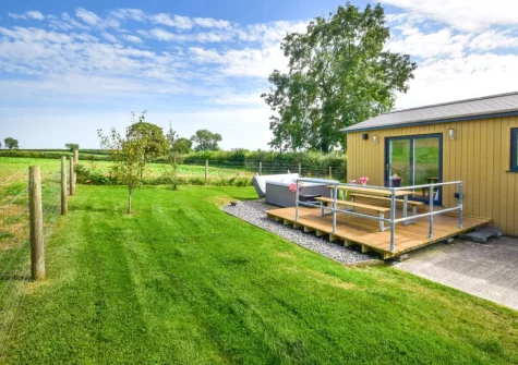 The decked patio, alfresco dining area, hot tub & garden at Windwhistle Lodge, South Molton