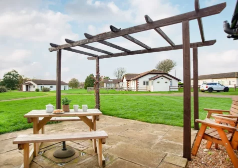 The patio, alfresco dining area & garden at Wonkey Donkey Cottage at Stoneleigh Holiday Village, Weston