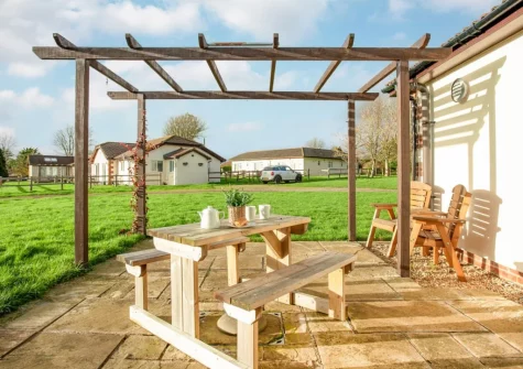 The patio, alfresco dining area & garden at Wonkey Donkey Cottage at Stoneleigh Holiday Village, Weston
