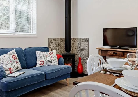 Woodcutters Cottage, Hennock is a delightful Dartmoor woodland retreat perfect for families and couples seeking adventure and relaxation. Enjoy resident alpacas, games facilities, a home cinema, & direct access to stunning South Devon attractions.