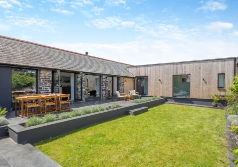 The patio, barbecue, alfresco dining area & enclosed courtyard garden at Woodside Barn, Hartland