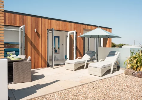 The patio, alfresco dining & outdoor sitting area at Woolacombe Retreat, Hillview, Mullacott