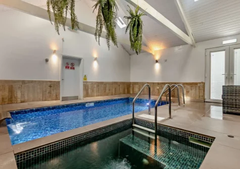 The private indoor swimming pool & hot tub at Woolstone Farmhouse, Box's Shop
