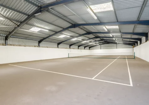 The shared indoor tennis court at Woolstone Teagues Trail, Box's Shop