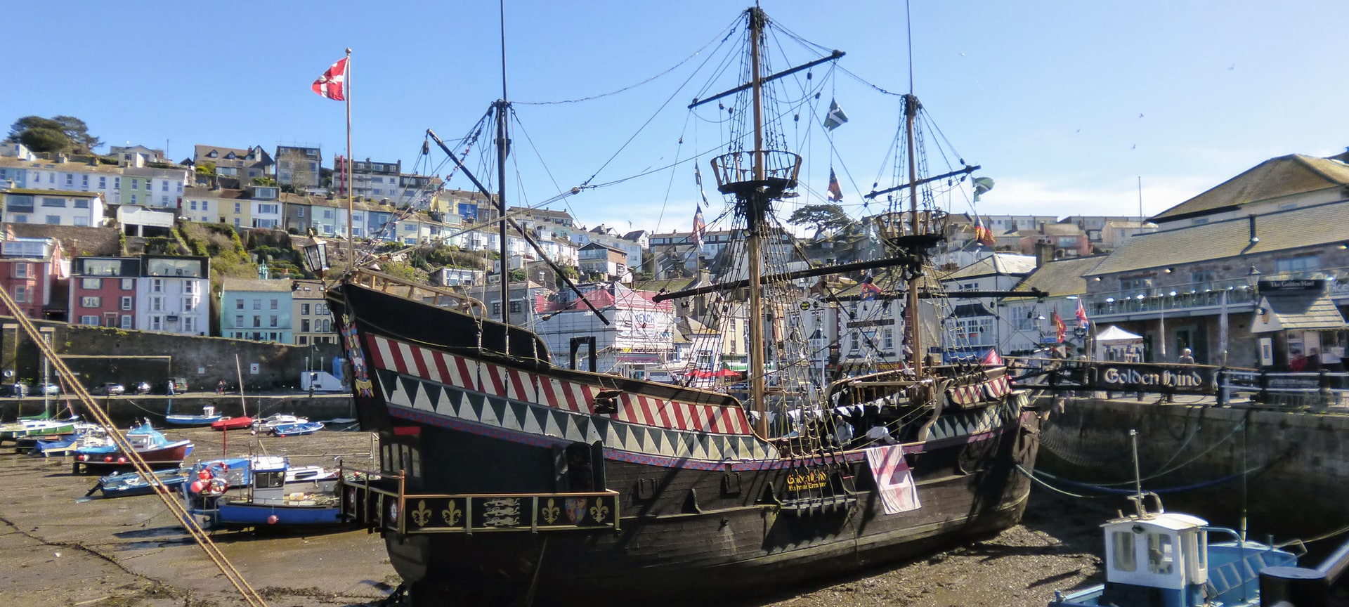 Located at the old fishing port of Brixham is The Golden Hind, a full sized and permanently moored replica of one of the most iconic exploration ships and a landmark tourist attraction in the town since 1964. Through the replica's five decks it tells the story of the life and times of the captain and crew along with conditions at sea during the 1600s through various exhibitions, re-enactments and interactive sessions. The idea is to allow visitors to really experience the sights, sounds and smells of life aboard a Tudor ship.