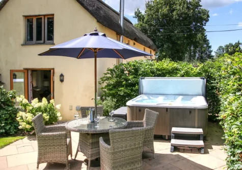 The patio, alfresco dining area & hot tub at Wrens Thatch, Ebberley