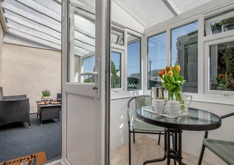 Step out onto the covered patio & outdoor sitting area